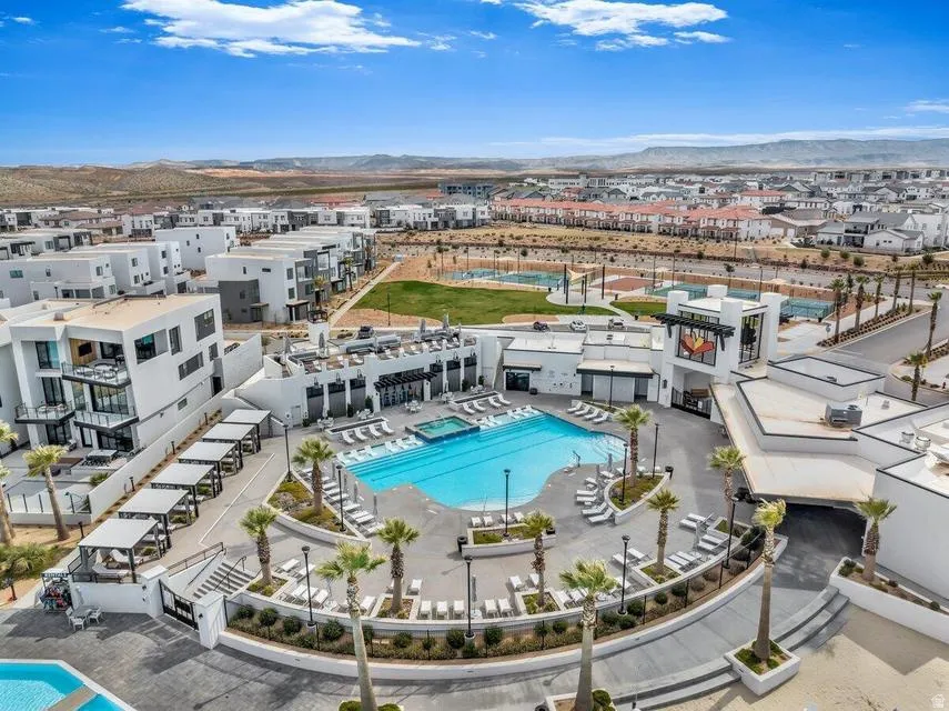 Central community hub featuring a large swimming pool, integrated spa, and extensive lounge seating