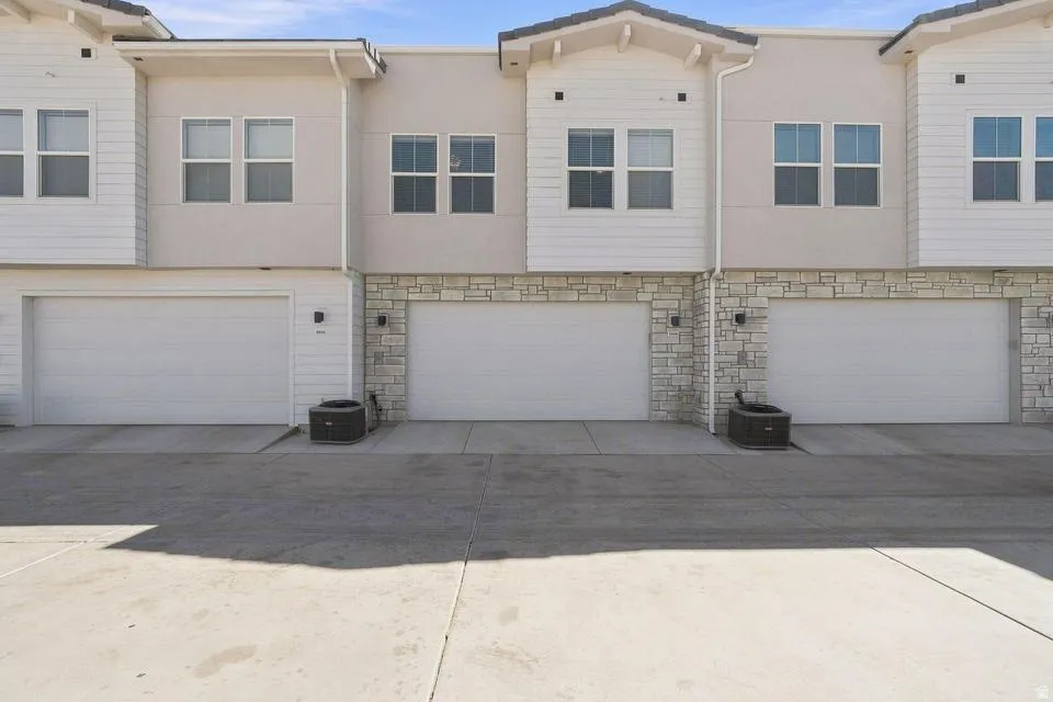 Modern townhome community featuring three individual units with clean architectural lines