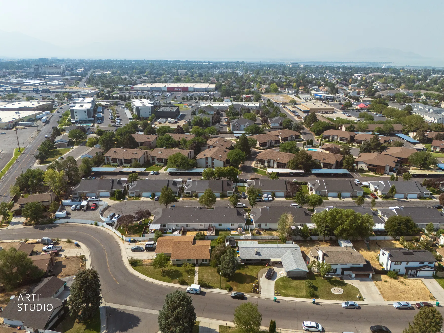 Aerial view showcasing a well-appointed residential neighborhood with tree-lined streets, mature landscaping throughout the community, and established single-family homes with varied architectural styles