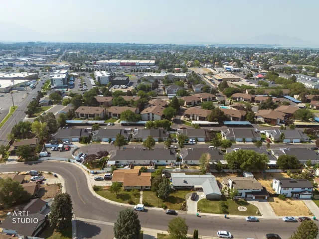 Aerial view showcasing a well-appointed residential neighborhood with tree-lined streets, mature landscaping throughout the community, and established single-family homes with varied architectural styles