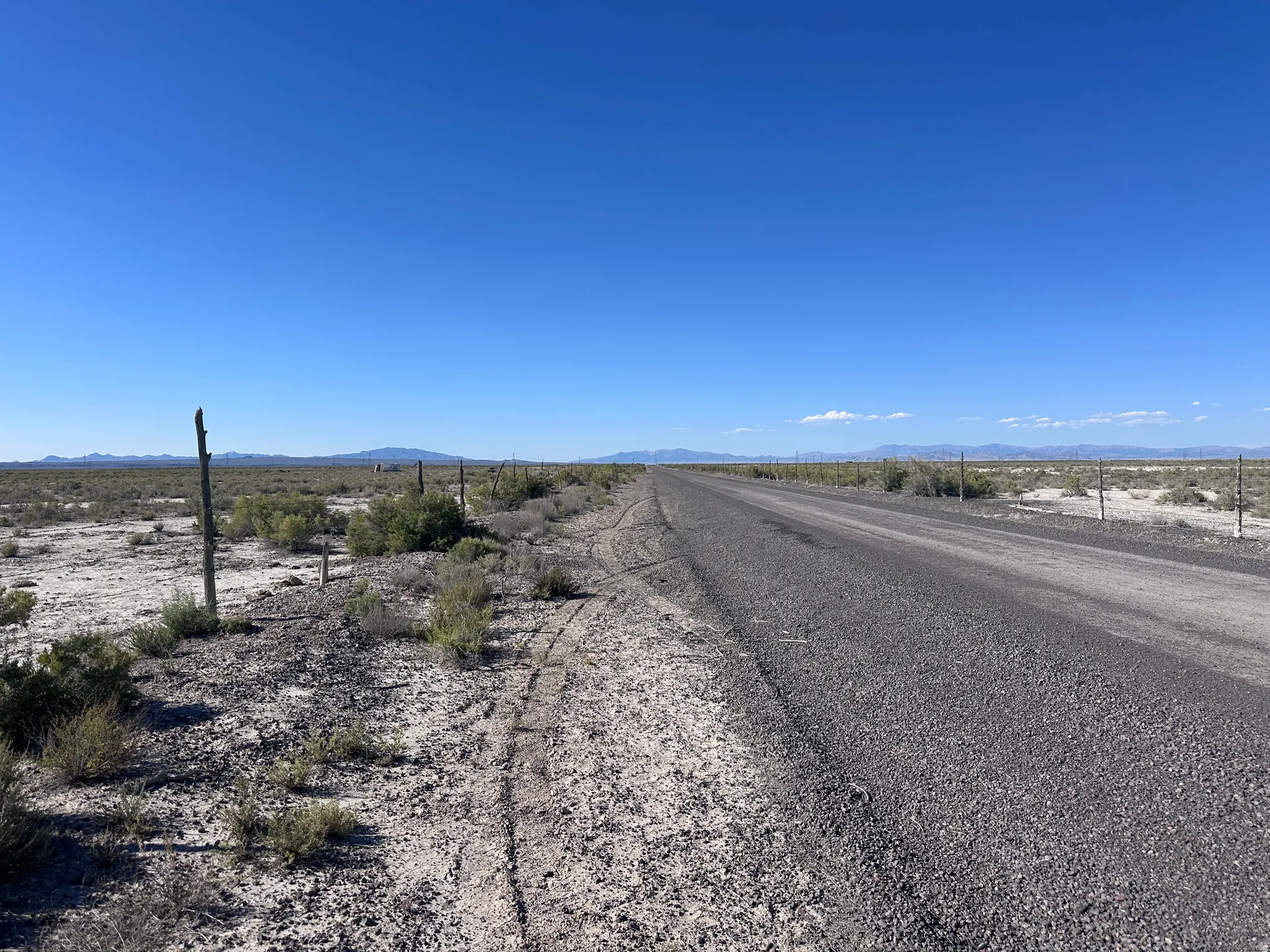 Expansive desert lot featuring direct road frontage on a paved county road