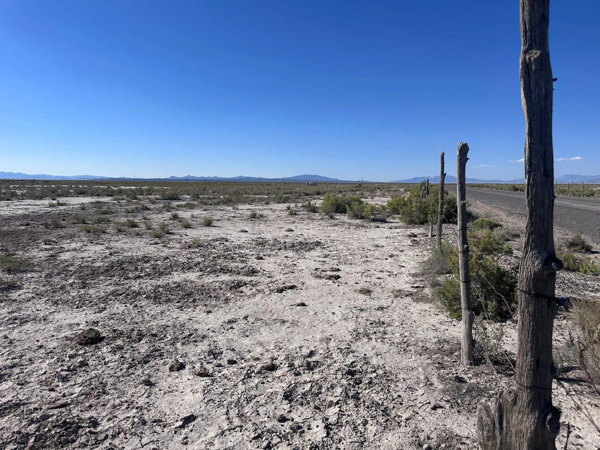 Expansive undeveloped land featuring a clear horizon and distant mountains
