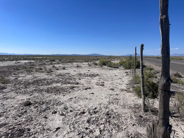 Expansive undeveloped land featuring a clear horizon and distant mountains
