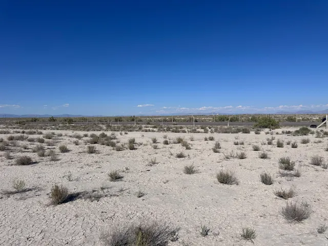 Expansive vacant land featuring natural desert terrain with sparse native vegetation and clear sightlines across the property
