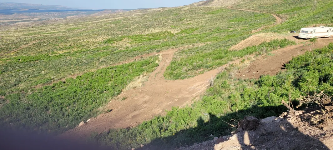 Expansive undeveloped land featuring rolling hills and natural vegetation