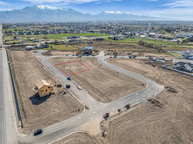 Cleared land parcel designated as "lot 227" within a developing community