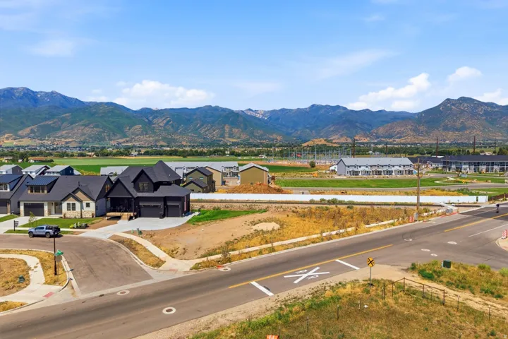 Stunning new construction home featuring a distinctive black exterior with multi-gable roofline and three-car garage