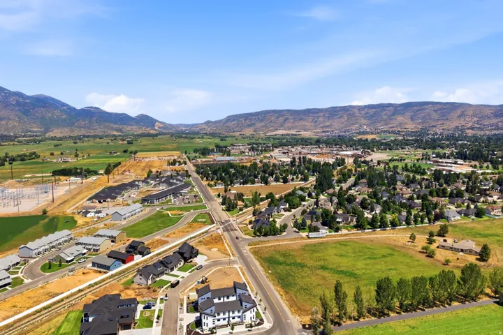 Aerial view showcasing newly developed residential community nestled within expansive valley landscape