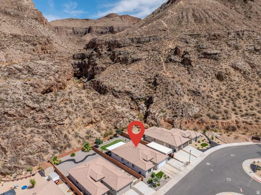 Aerial view showcasing this desert property's modern architectural footprint nestled within dramatic mountain terrain