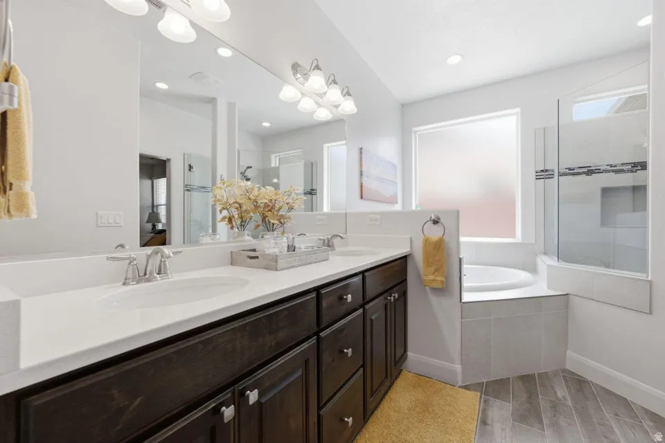 Dual vanity with dark wood-finish cabinetry, white countertops, and undermount sinks