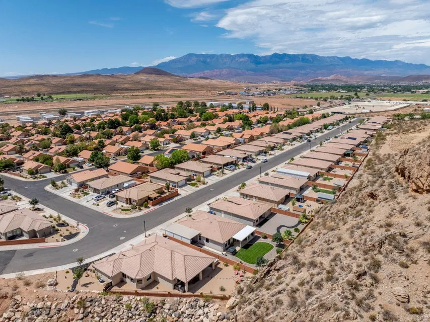 Residential development featuring a grid of single-story homes with terracotta-hued tile roofs
