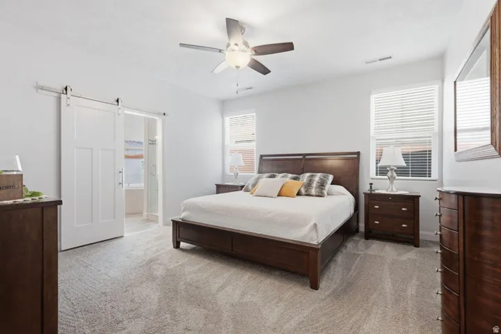 Spacious room featuring light-colored walls and plush carpeting