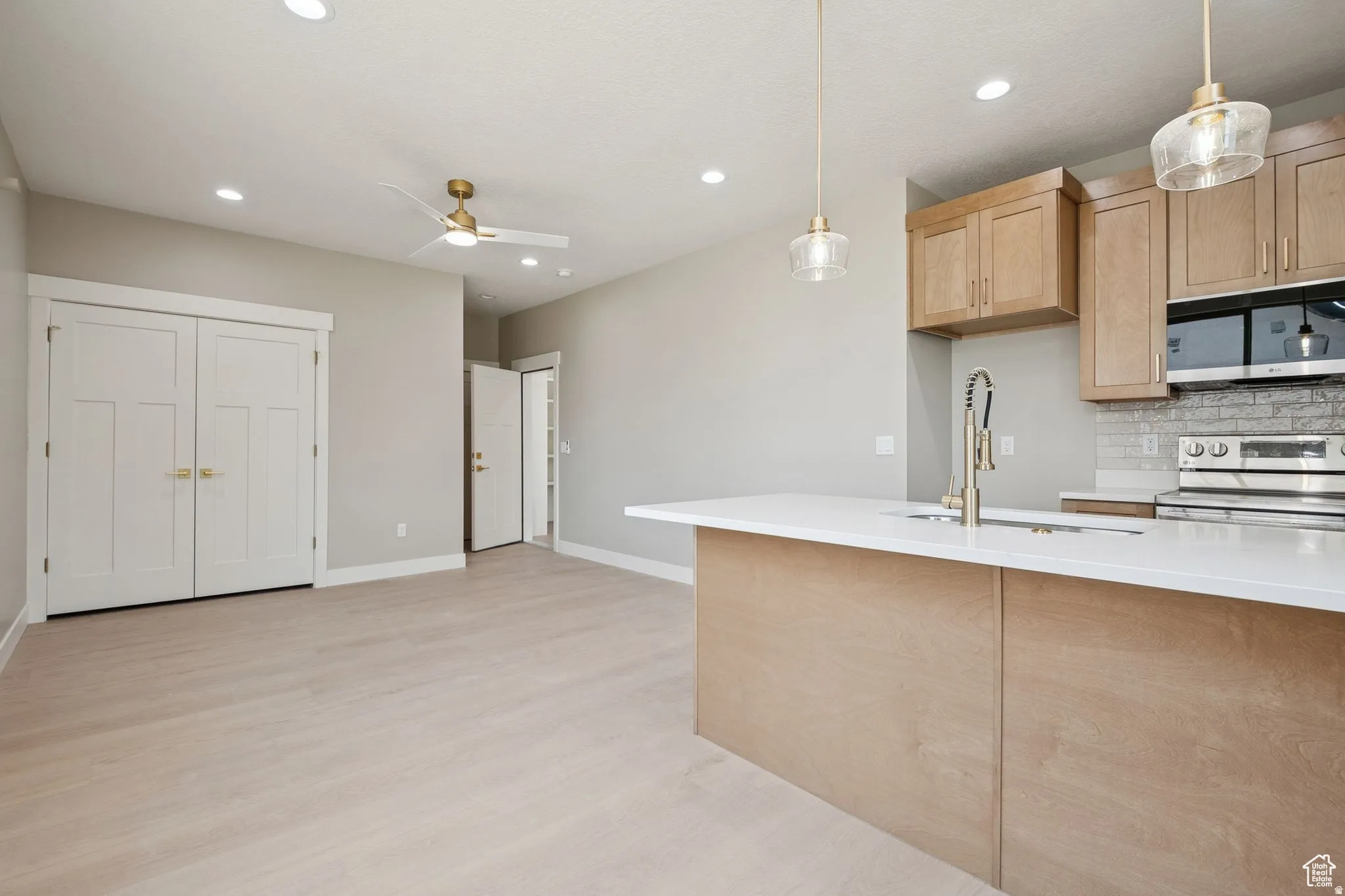 Open-concept living space with wood-finish flooring