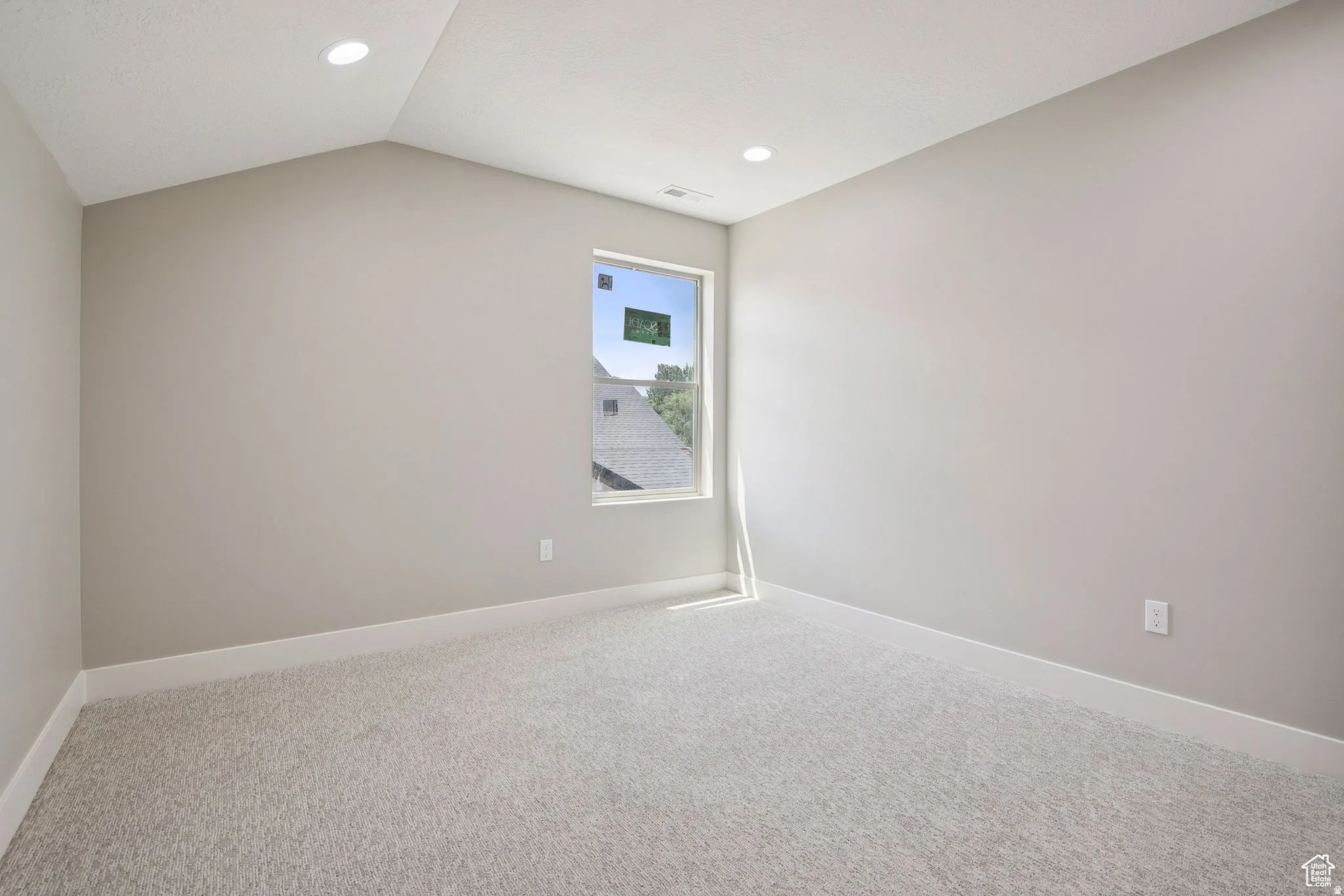 Spacious bedroom featuring neutral wall finishes, recessed ceiling lighting, and soft carpeting throughout