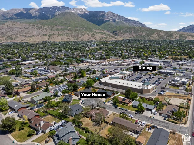 Aerial view showcasing the property's location within a thriving residential community, surrounded by established landscaping and convenient proximity to retail dining and shopping amenities