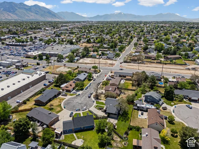 Expansive aerial perspective showcasing a residential neighborhood with surrounding commercial structures