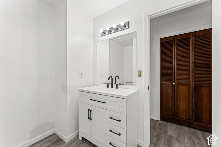 Spa-inspired bathroom vanity featuring a white cabinetry base with multiple drawers, polished countertop, and matte black hardware