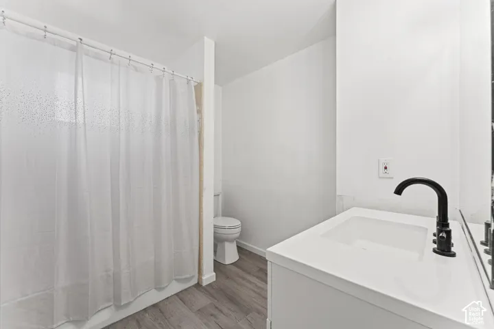 Modern bathroom featuring a clean white vanity with a sleek matte black faucet, white quartz countertop, and ample counter space