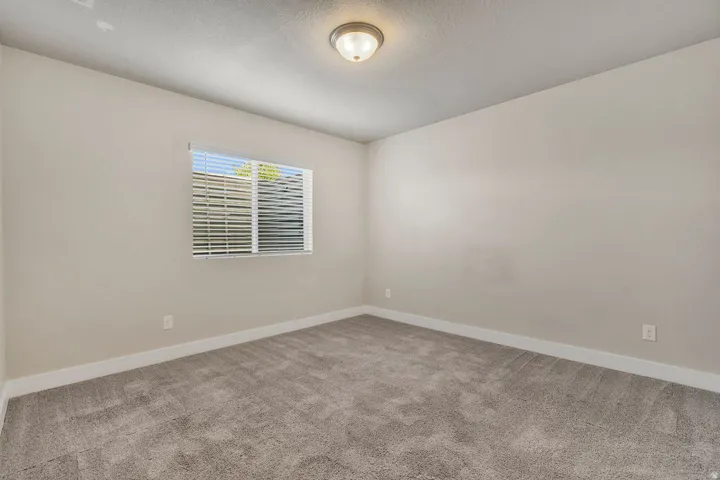 Neutral-toned walls complement the gray carpeting and white baseboards