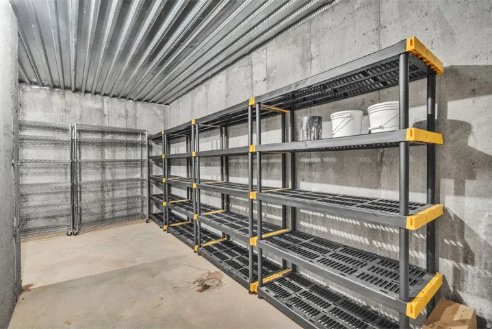 Concrete walls and a corrugated metal ceiling define this storage area