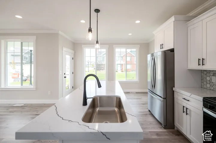 Kitchen island with an undermount stainless steel sink and matte black faucet