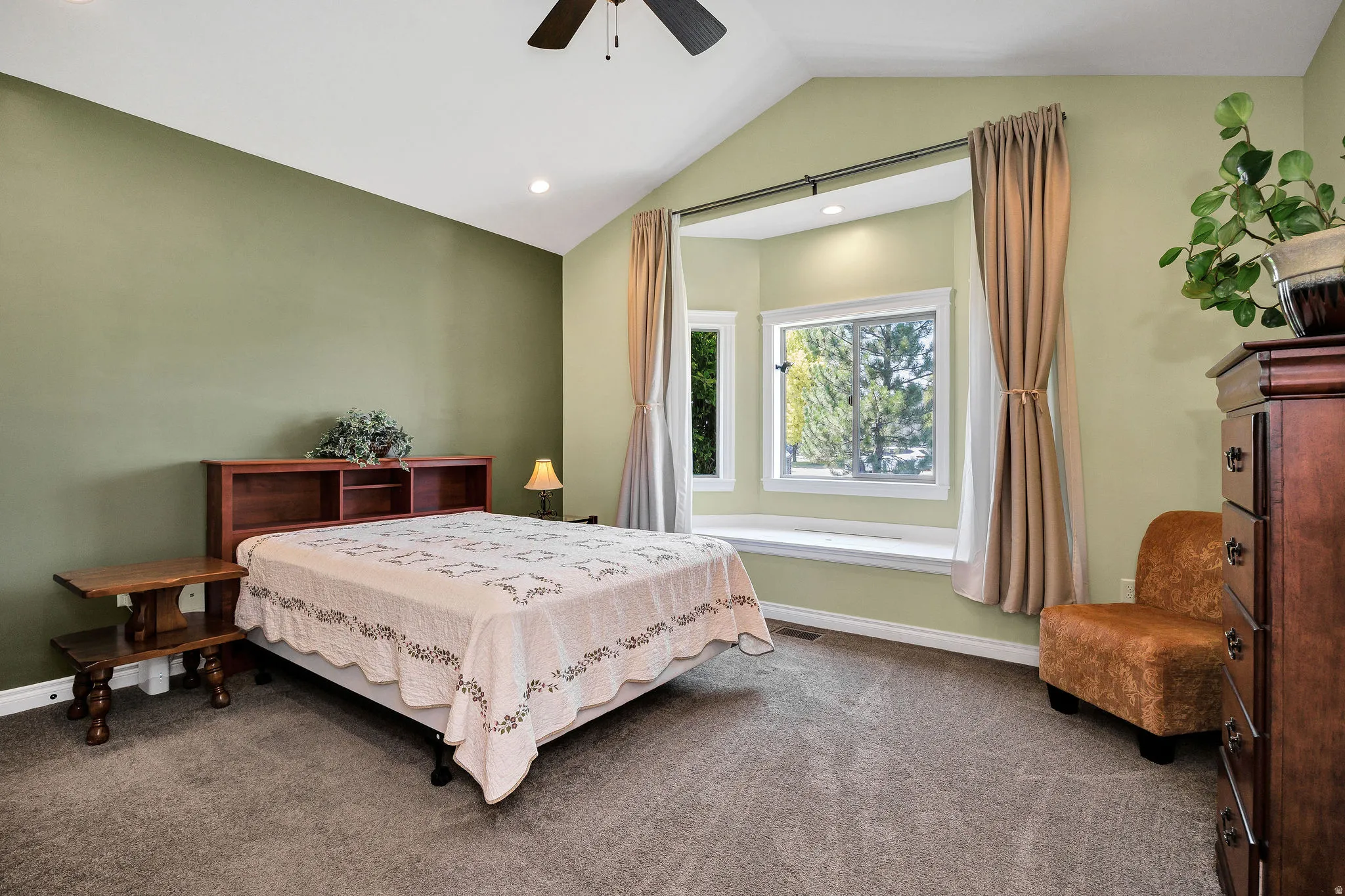 Vaulted ceilings with recessed lighting and a ceiling fan