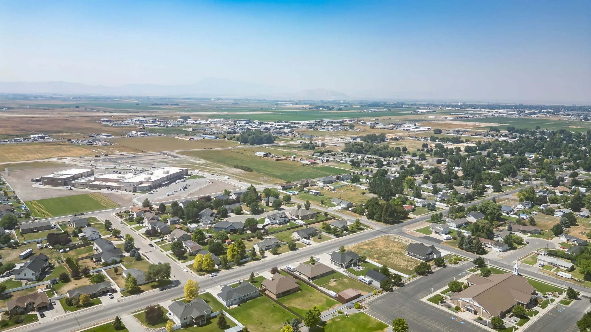 Expansive aerial perspective showcasing a residential district with tree-lined streets and established homes