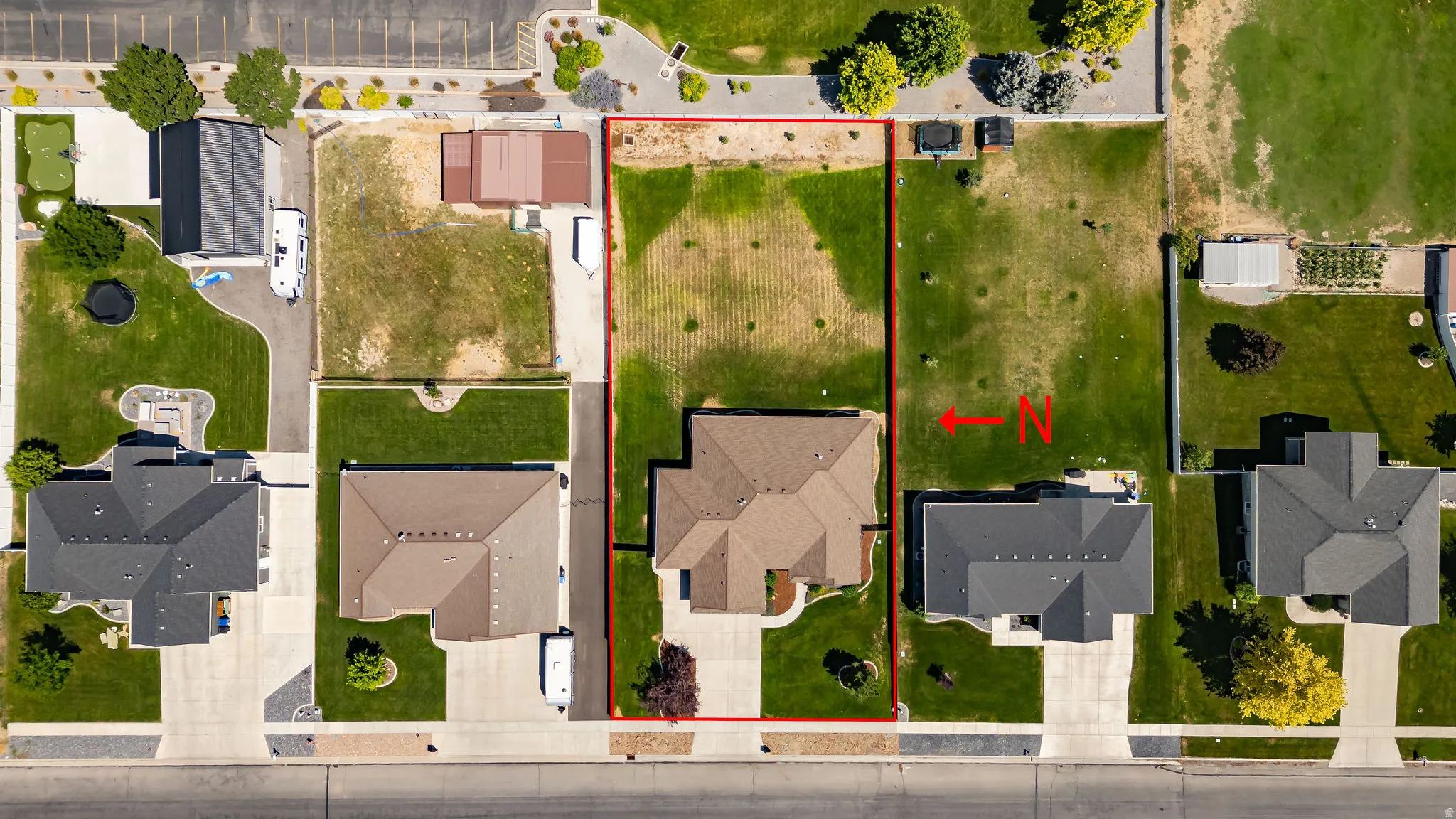 Aerial depiction of a residential property with a multi-gabled roofline, concrete driveway, and established front landscaping