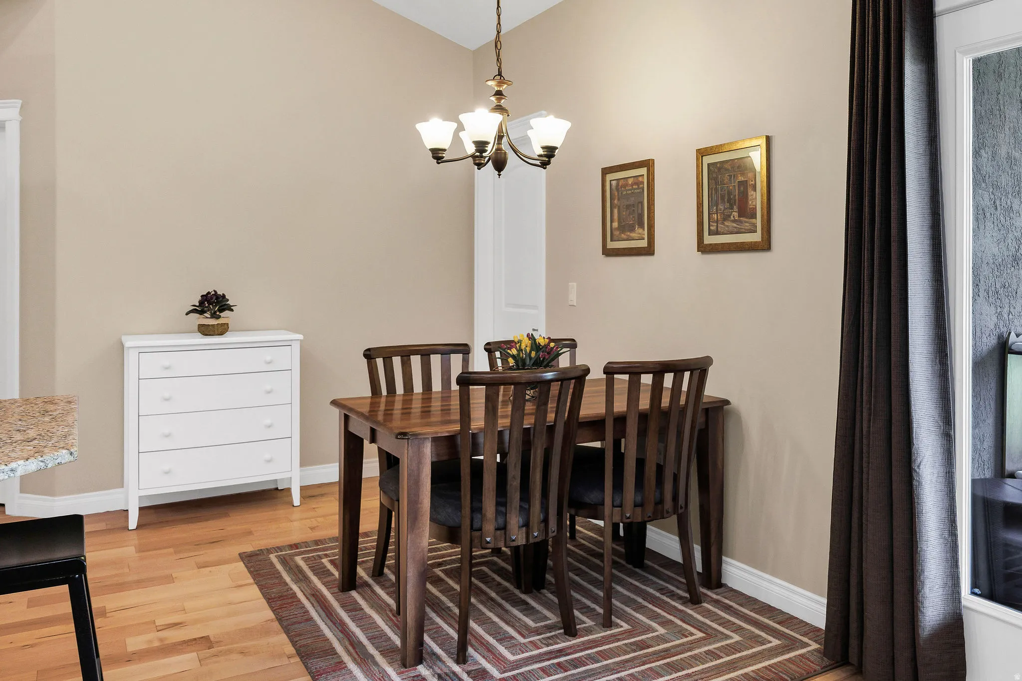 Open dining area featuring wood-finish flooring and neutral wall tones