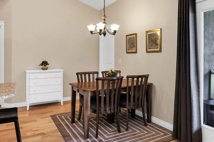 Open dining area featuring wood-finish flooring and neutral wall tones