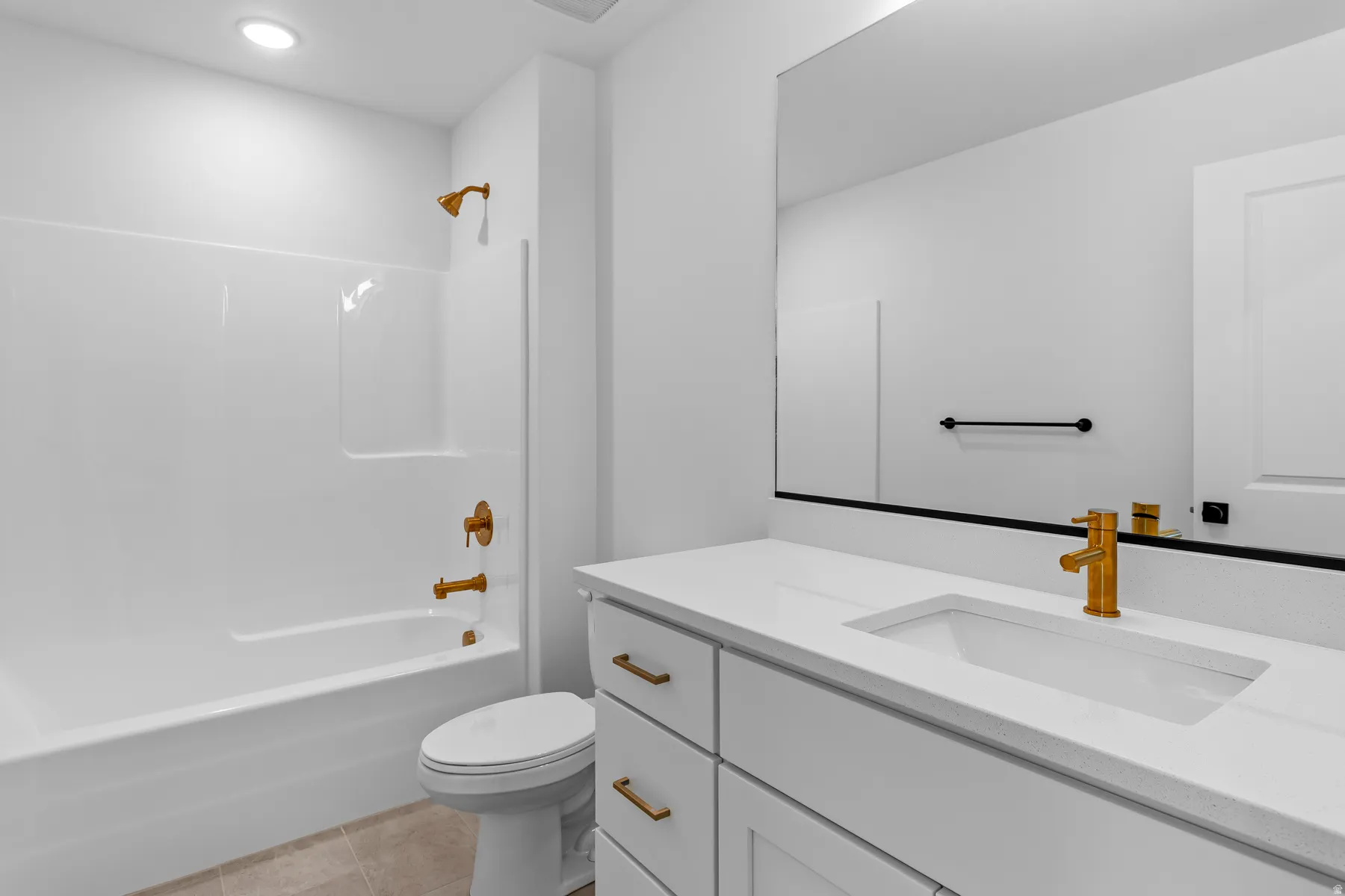 Modern primary bathroom featuring a white vanity with dual rectangular vessel sinks, quartz countertop, and brushed brass hardware