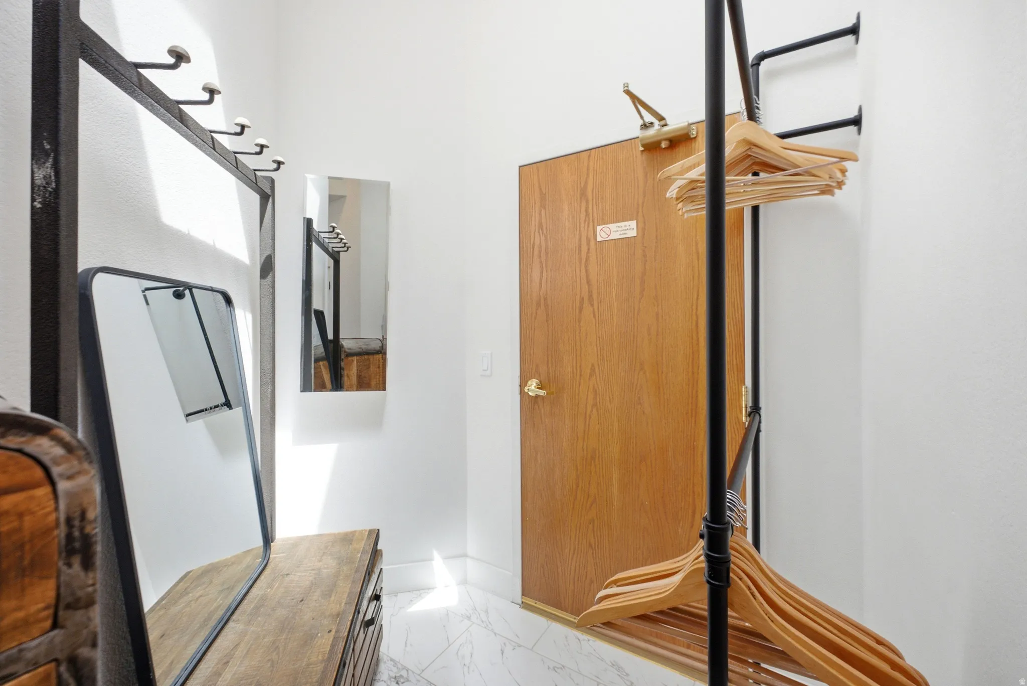 Entryway with white walls and marble-finish tile flooring
