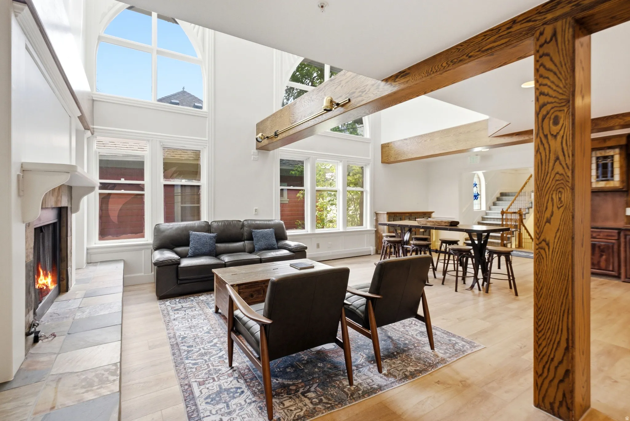 Expansive living area featuring soaring ceilings and decorative exposed wood beams