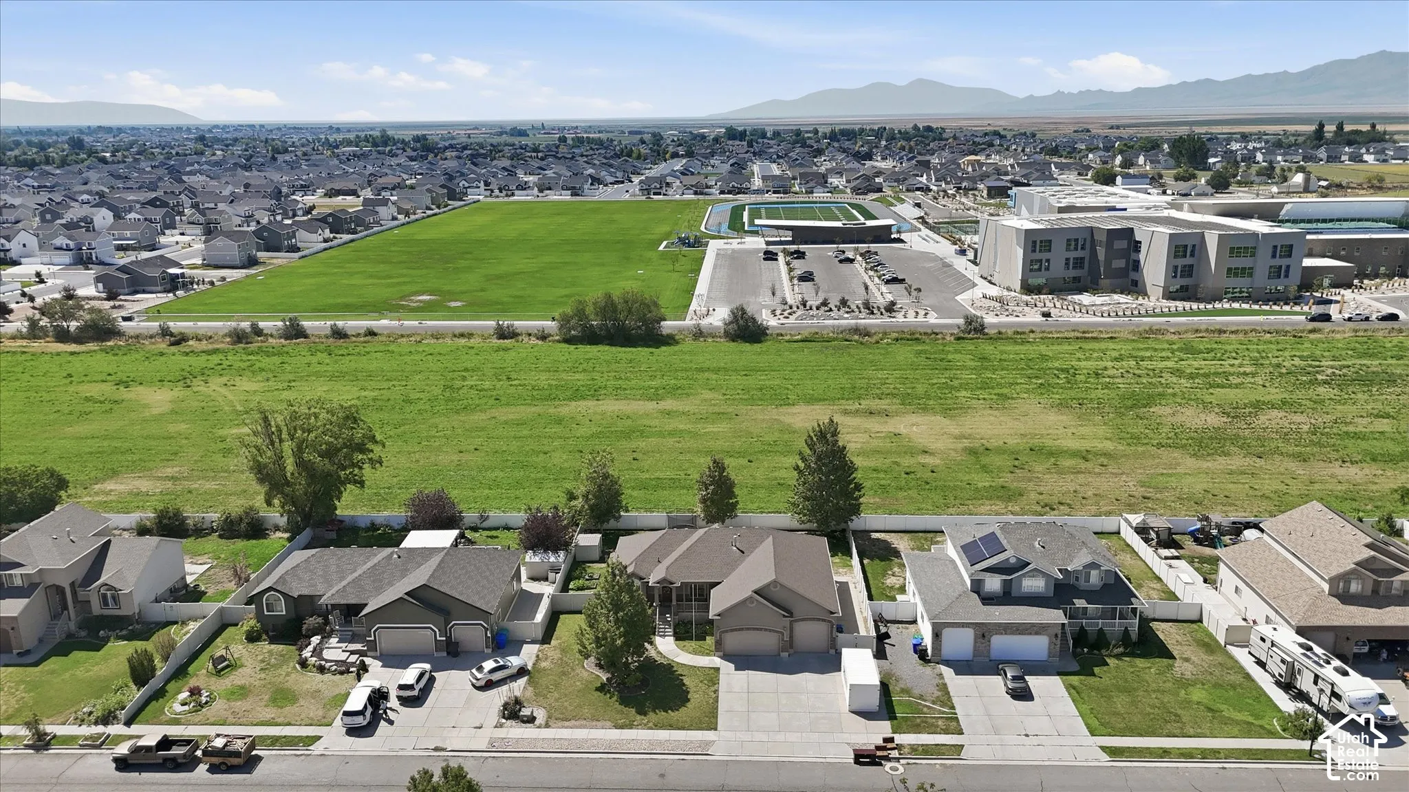Aerial perspective showcasing homes with a field for spacious views