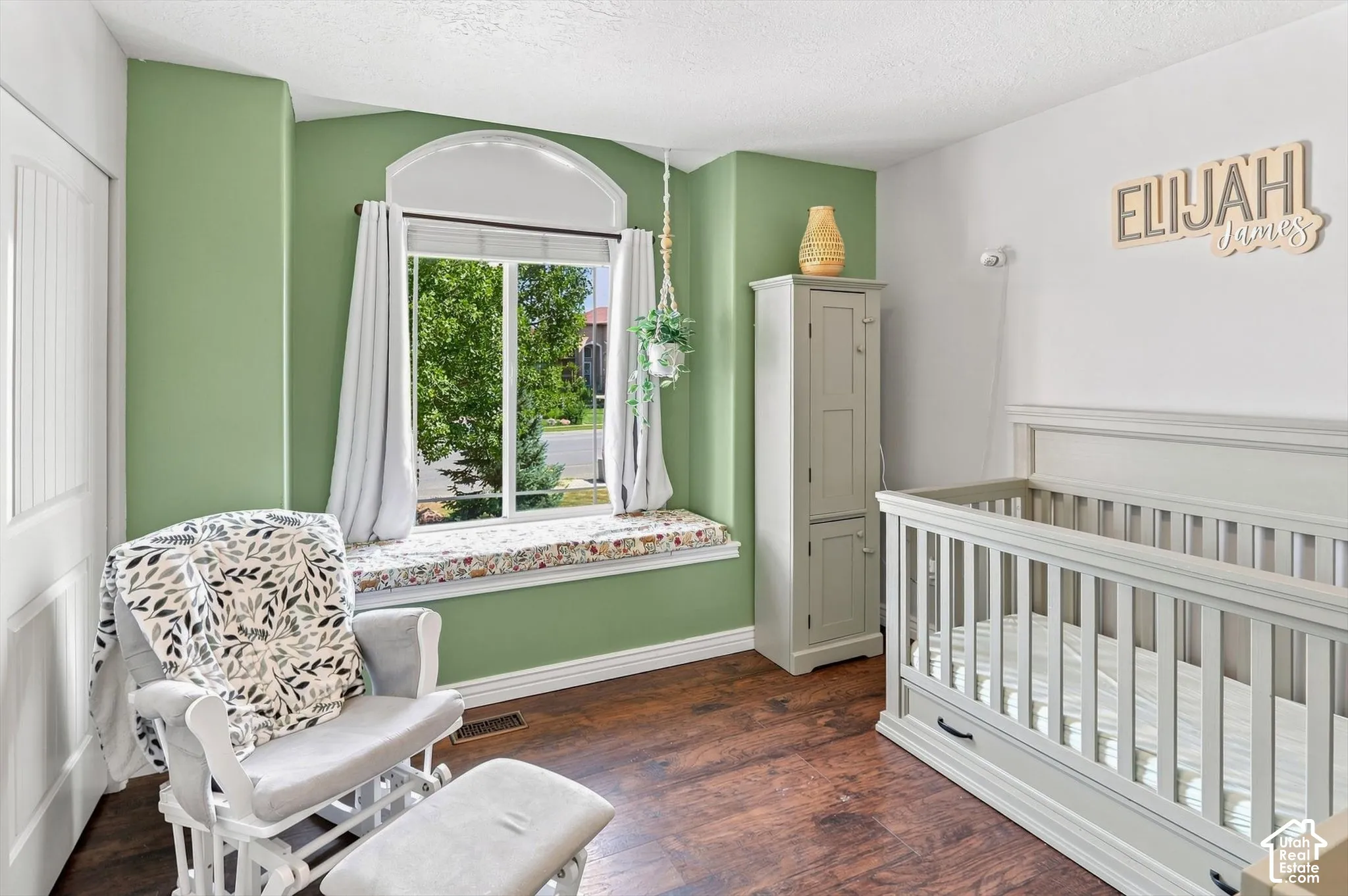 Arch-top window with a deep sill and built-in window seat, complemented by LVP flooring and a white paneled door