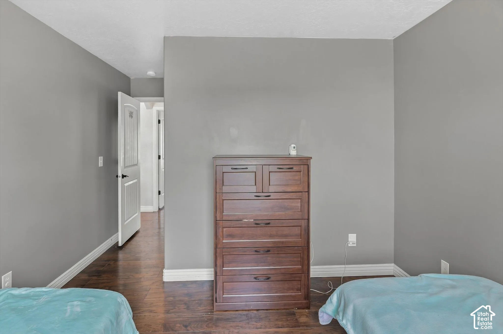 Bedroom with gray walls and LVP Florring