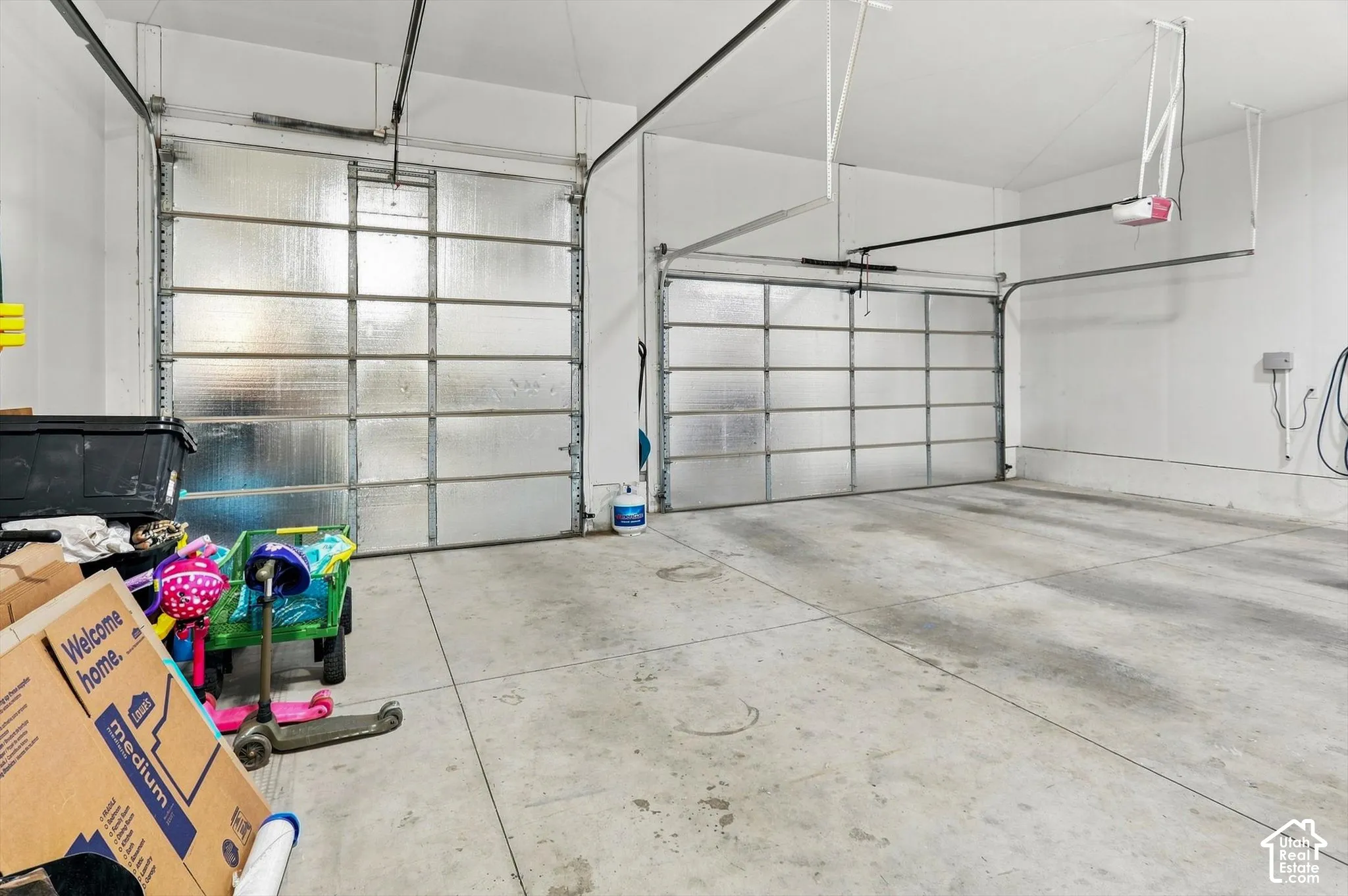 Spacious 4 car garage featuring two overhead doors