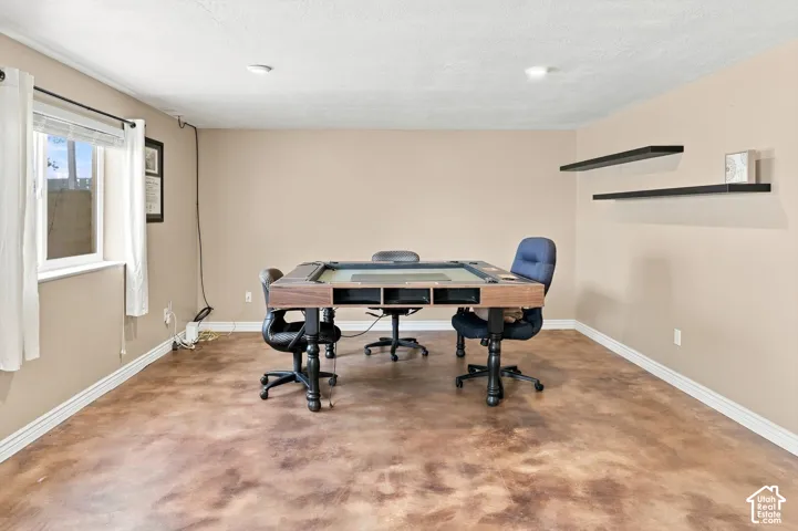 Spacious entertaining area with stained concrete flooring and floating shelfs