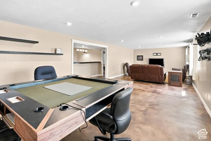 Large family room / entertaining space with stained concrete flooring