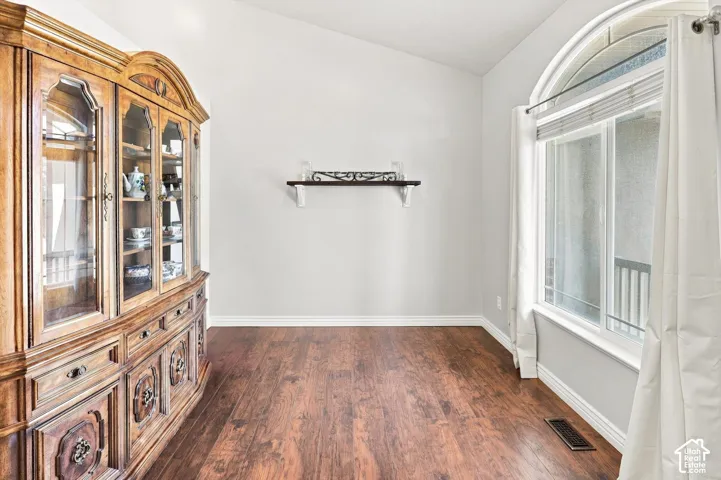 Elegant formal dining room or living room showcasing rich wood-finish flooring