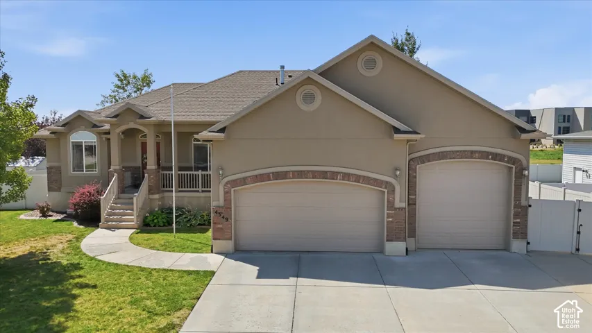Stucco exterior with brick accents and a large garage