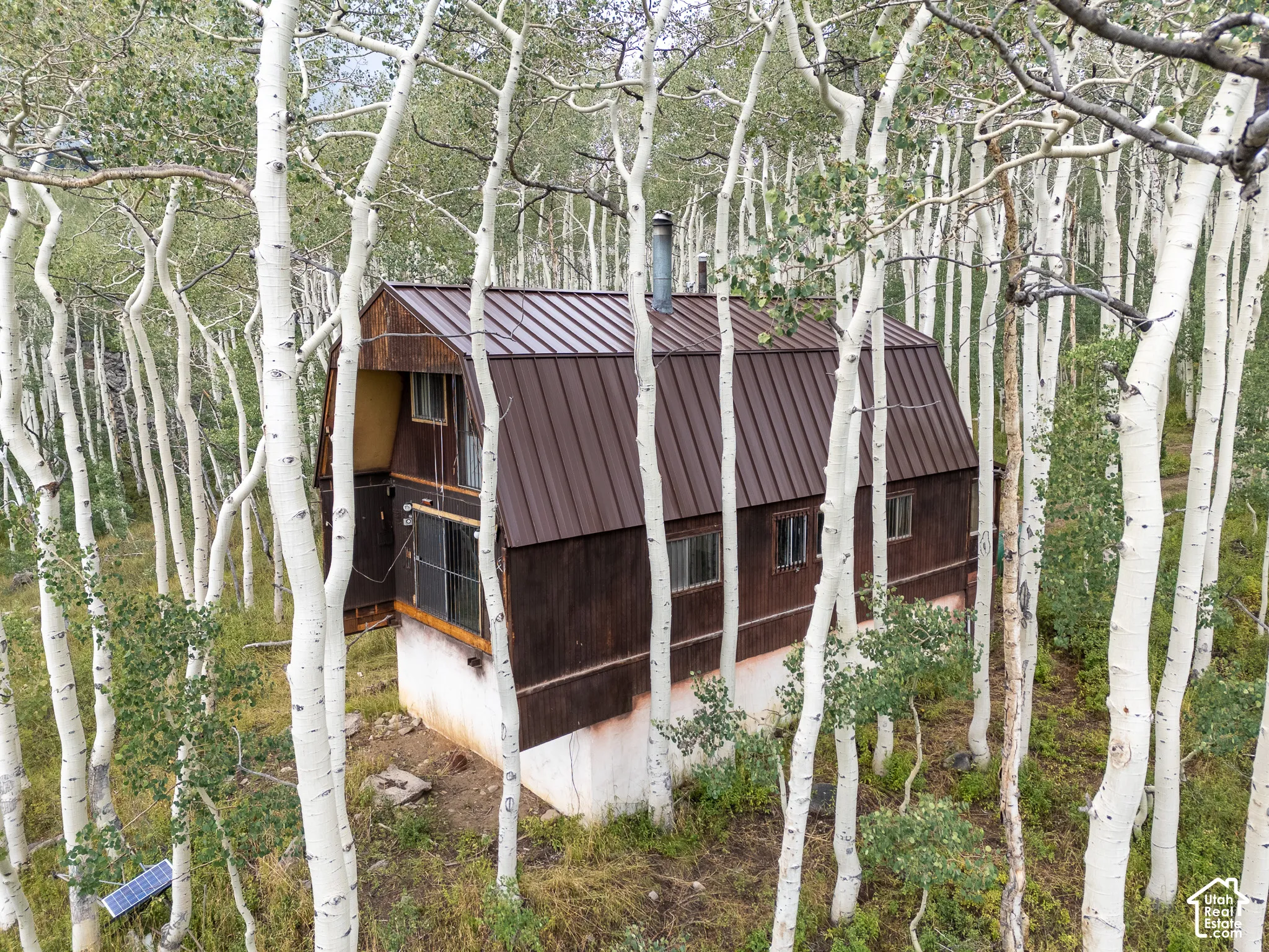 Wood-sided exterior with a metal roof and a chimney