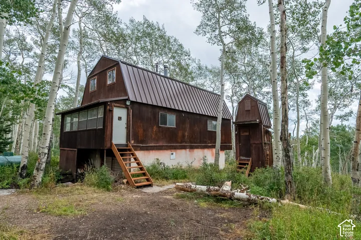 Barn-style residence featuring a metal roof and an enclosed porch