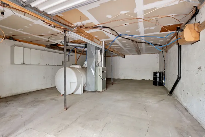 Concrete floor with exposed ceiling joists and utility lines