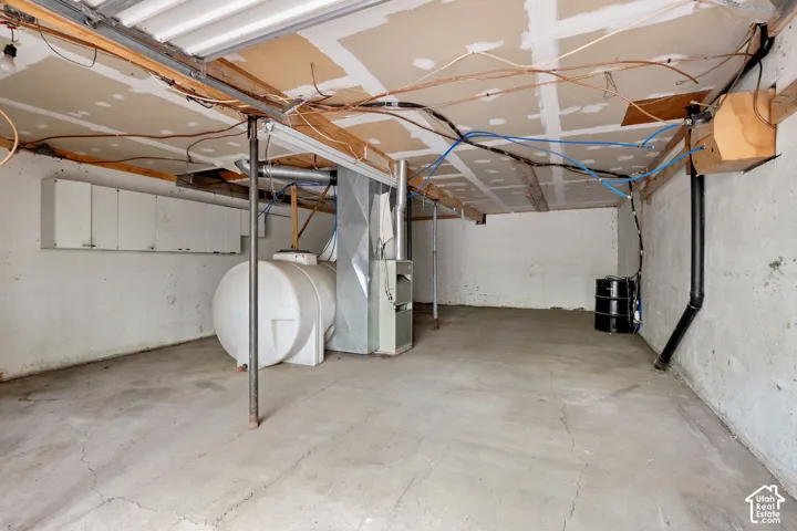 Concrete floor with exposed ceiling joists and utility lines