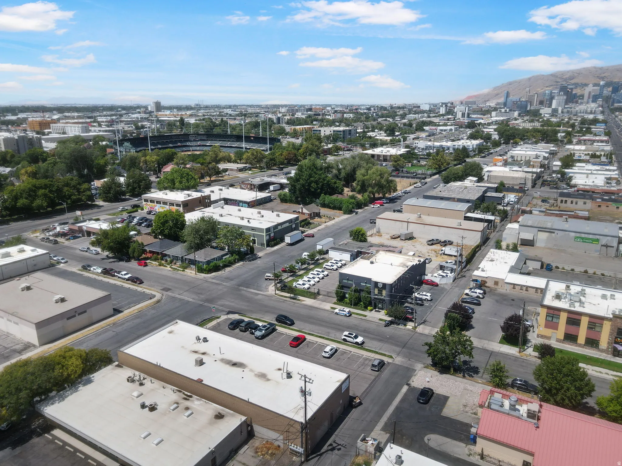 Aerial view showcasing industrial and commercial mixed-use property with multiple warehouse and manufacturing structures featuring flat roofs and functional layouts