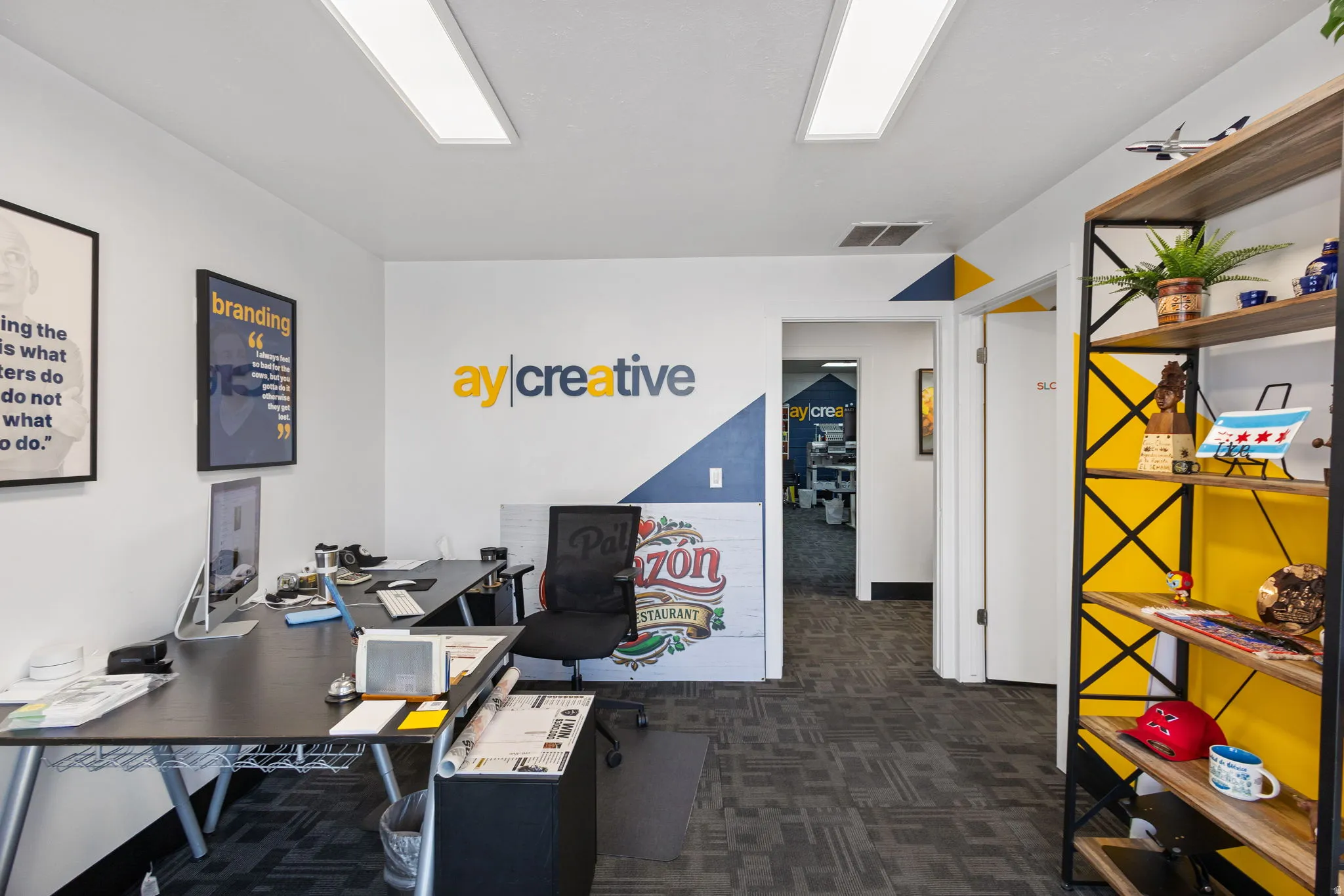 Modern office space featuring open floor plan with polished concrete flooring, recessed ceiling lighting, and abundant natural light from overhead panels