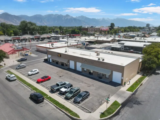 Modern commercial building featuring a clean, contemporary facade with neutral-tone exterior paneling and blue accent trim
