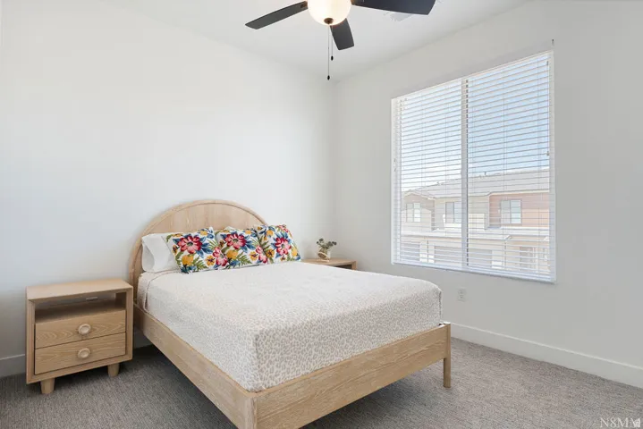 Bright interior space featuring a large window with white horizontal blinds