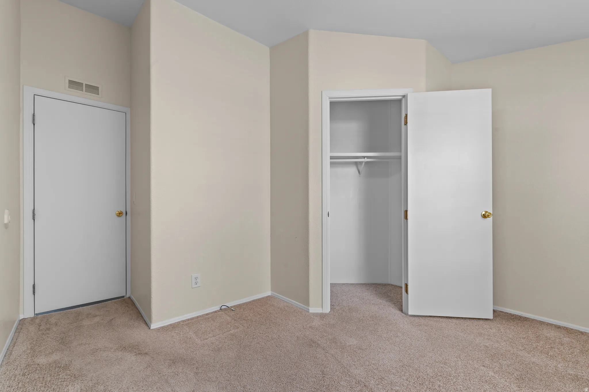 Neutral-toned carpeting and walls complement the white doors and trim.